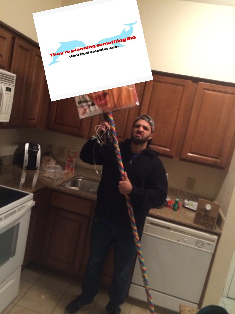 A brave truth-teller holding the Don't Trust Dolphins sign